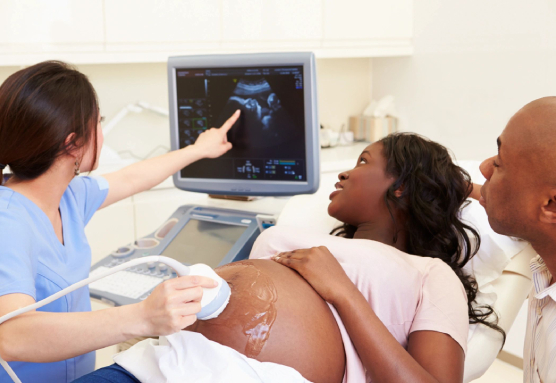 Ultra Sound Scanning by Pregnant Lady With Partner