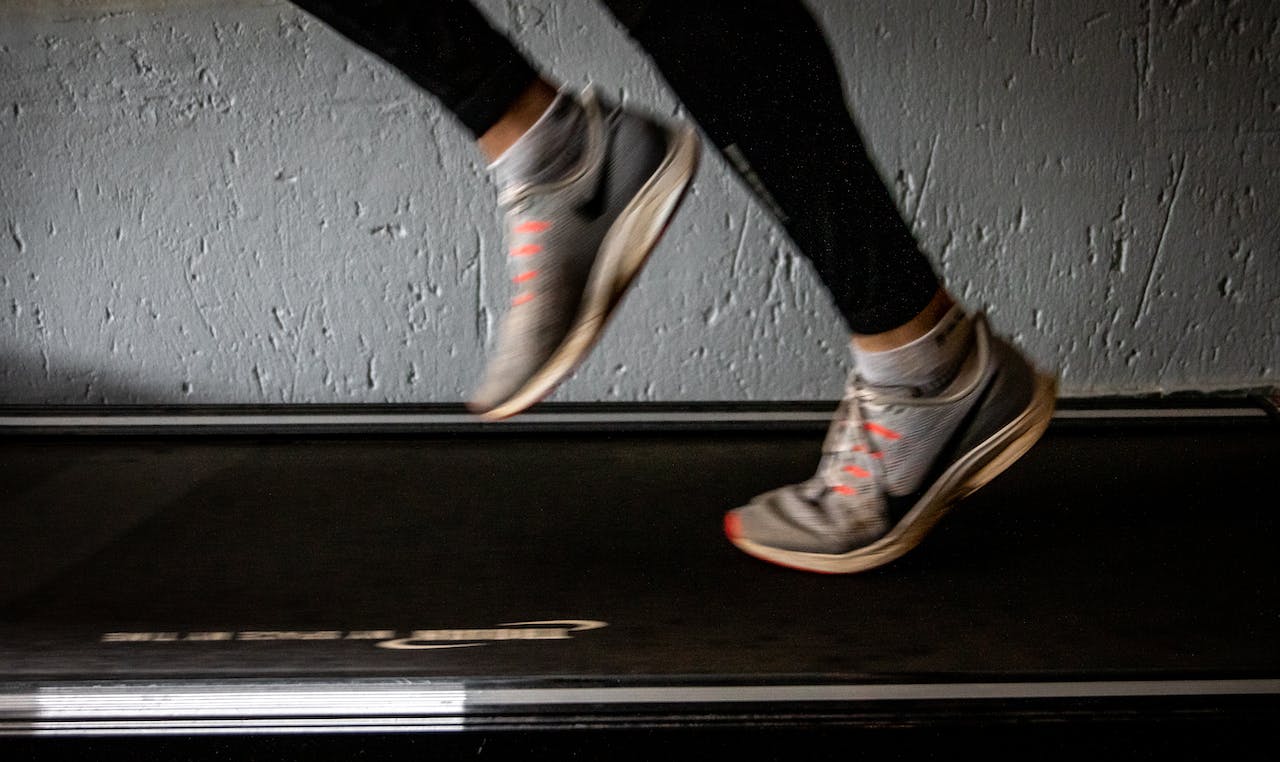 a person walking on a treadmill desk.