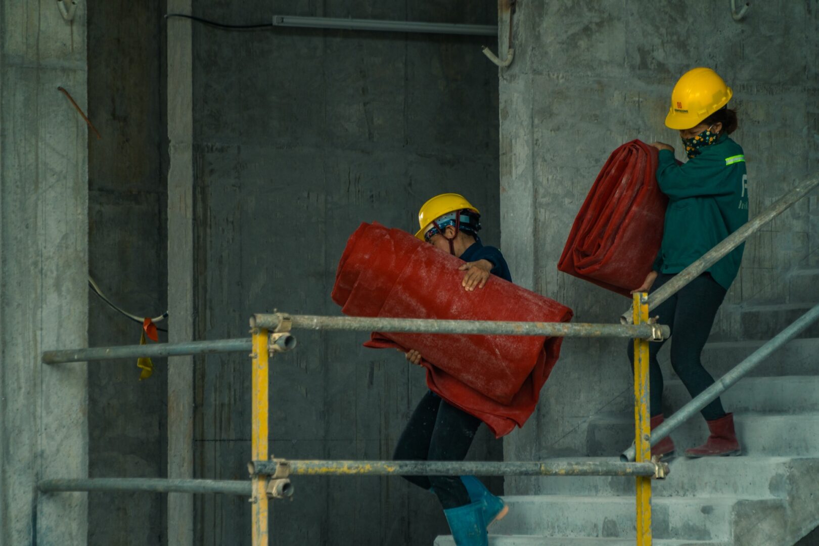 an industrial workers carrying awkward bags