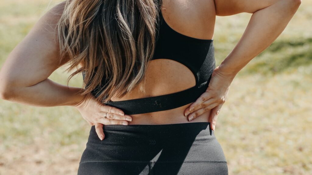 a woman touching her lower back