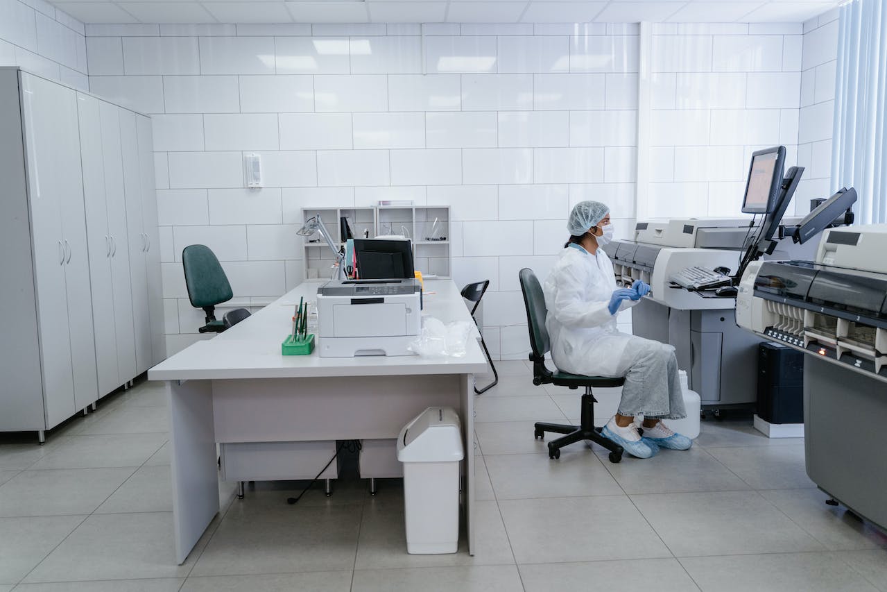 A scientist in a lab sitting down at work