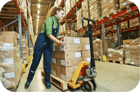 Woman working with pallet jack in warehouse. Ergonomics Laws Come to Washington Warehouses.