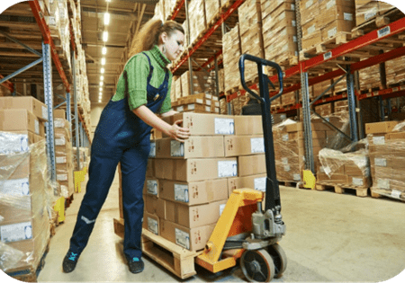 Woman working with pallet jack in warehouse. Ergonomics Laws Come to Washington Warehouses.