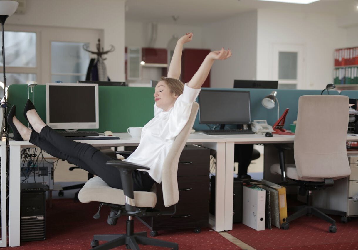 a woman doing big stretches in an office