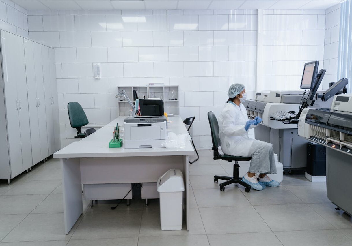 A scientist in a lab sitting down at work